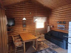 a living room with a table and a couch at Cottages SAA in Punkaharju