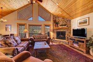 a living room with a couch and a tv at Aspen Lookout by Great Western Lodging in Breckenridge