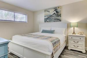 a white bedroom with a bed and a window at 0204 Seaside Sanctuary by Atlantic Towers in Carolina Beach