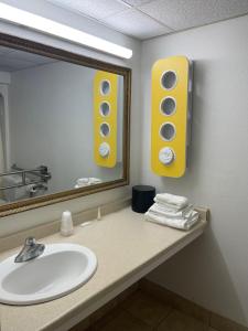 a bathroom with a sink and a mirror at Travelodge by Wyndham Vernon CT in Vernon
