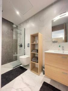 a bathroom with a sink and a toilet and a shower at Tour 33 : Appartement chic en plein cœur de Casa in Casablanca
