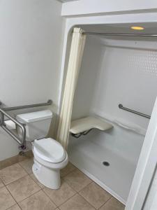 a bathroom with a toilet and a shower at Travelodge by Wyndham Vernon CT in Vernon