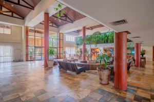 an empty lobby with a large room with plants at Beach Park Resort - Suites in Aquiraz