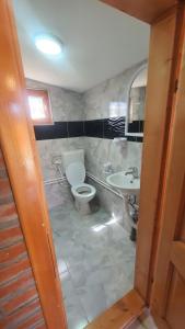 a bathroom with a toilet and a sink at ETNO SELO VEZIROV RANČ in Sjenica +29 photos