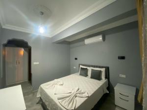 a bedroom with a large bed with white sheets at Aspawa Hotel in Pamukkale