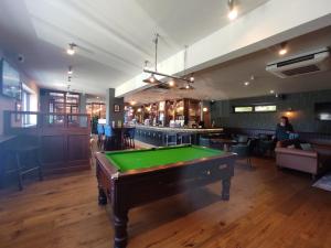 a pool table in a room with a bar at Torbay Holiday Home at The Waterside Holiday Park - With Deck and Sea View in Torquay