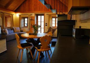 a kitchen and living room with a table and chairs at Alpine Retreat Apartments Šurc in Rateče