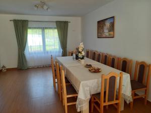 a dining room with a table and some chairs at Casa de la Moară in Tureac