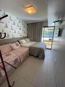 a bedroom with two beds and a wall with sails at EKOARA BEIRA MAR 127 in Porto De Galinhas +36 photos