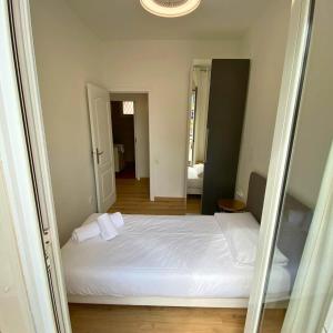 バルセロナにあるAmazing Apartment in Poblenou with 3 bedroomsのベッドルーム(白いベッド1台、鏡付)