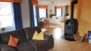 a living room with a couch and a wood stove at Ferienhaus Wellisch in Lohberg