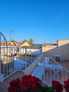 a balcony with a table and chairs and flowers at Hotel Blue Spot in Malgrat de Mar
