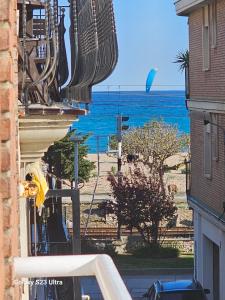 a view of the ocean from between two buildings at Hotel Blue Spot in Malgrat de Mar