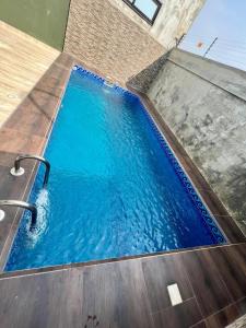 a swimming pool with blue water in a building at Havre de paix in Cotonou
