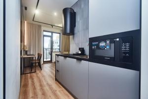a kitchen with a counter top with a microwave at Apart Hotel Acropolis in Odesa