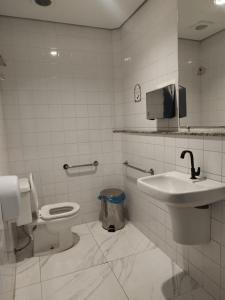 a bathroom with a toilet and a sink at Trem Chic in Belo Horizonte +72 photos