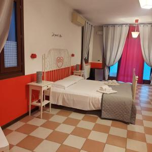 een slaapkamer met een bed en een tafel en stoelen bij Casa di Alice in Chioggia