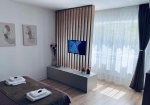 a bedroom with a bed and a large window at Central luxury apartment Iasi in Iaşi