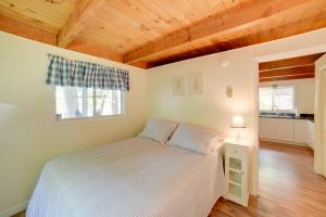 a bedroom with a bed and a wooden ceiling at 5 Mi to Fox State Forest Lakefront Home with Dock in Henniker