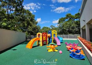 a playground with a play equipment on a green floor at Hotel Park Veredas in Rio Quente