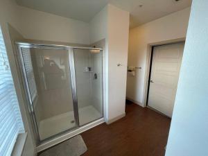 a bathroom with a shower with a glass door at BEAUTIFUL STUDIO 7MIN FROM THE GALLERIA MALL in Houston