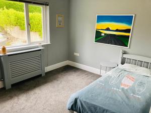 a bedroom with a bed and a window at Beautiful 4-Bed House with countryside views in Haverfordwest