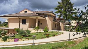 a large house with a garden in front of it at Tenuta Nonno Peppe in Fermo