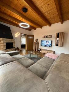 a living room with a couch and a flat screen tv at Moderner Bungalow in Mönchengladbach in Mönchengladbach