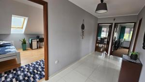 a living room with a bed and a mirror at Apartament na Gryfa 8 in Stężyca