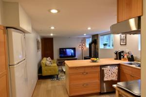 シアトルにあるUW Cozy - Quiet Home, Perfect for Family and Groupのキッチン(白い冷蔵庫、テレビ付)