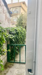 a door with a green railing in front of a building at Casa Elisa 8 in Bellaria-Igea Marina