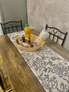 a basket of food and a drink on a table at Casa Elisa 8 in Bellaria-Igea Marina