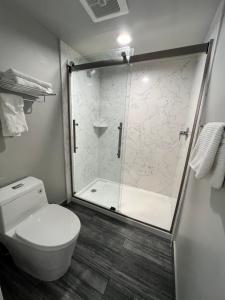 a bathroom with a shower with a toilet and a shower at Signature Inn Santa Clara in Santa Clara