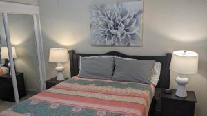 a bedroom with a bed with two lamps and a painting at Princesa de Penasco B208 - Family Beach Getaway in Puerto Peñasco +29 photos