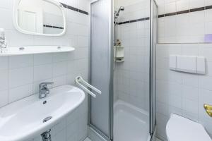 a white bathroom with a sink and a shower at Mountain Horse Ranch Vienna Alps 