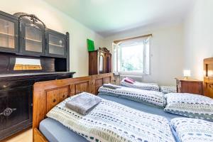 a bedroom with three beds and a dresser at Mountain Horse Ranch Vienna Alps 