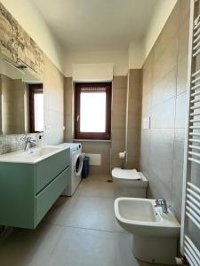a bathroom with two sinks and a washing machine in it at Red & Blue apartments in Termoli +13 photos
