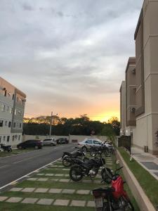 a row of motorcycles parked on the side of a street at Apto inteiro - WiFi, ar condicionado in Cuiabá +12 photos