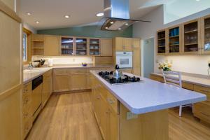 a large kitchen with wooden cabinets and a blue counter top at West Hills HideAway in Bend