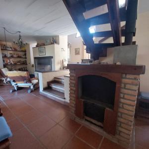 a living room with a fireplace with a tv at Yanasuspa Huasin & Sol del Pilar in Tafí del Valle