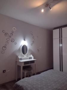 a bedroom with a sink and a mirror at Apartment AMare in Šibenik