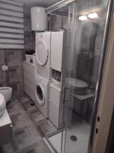 a bathroom with a washing machine and a washer at Apartment AMare in Šibenik +34 photos