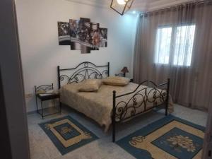 a bedroom with a bed and a window at DAR EL3EZ in Sicca Veneria