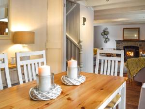 una mesa de comedor con velas encima en Penlan Cottage, en Cwrt-newydd