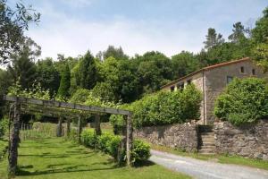 an entrance to an old building and a stone wall at Casa do Cebro Casa con piscina y jacuzzi privados in Santiago de Compostela