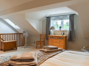 1 dormitorio con cama, escritorio y ventana en Hoopers End en Sedgwick