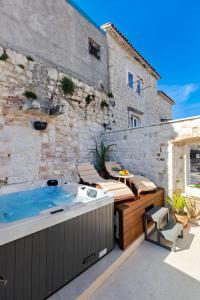 a hot tub on a patio next to a building at House Marijeta and Tonka in Trogir