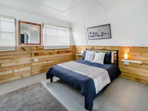 a bedroom with wooden walls and a bed in it at The Honey Pod - Uk44780 in Hoel-galed