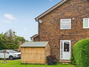 a brick house with a small shed in front of it at Pennies Retreat in Glossop