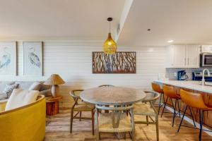 a kitchen and dining room with a table and chairs at One Seagrove Place 0206 in Santa Rosa Beach